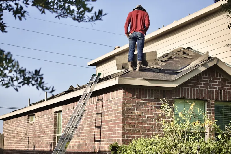 Professional roofer working on a residential roof in Hayground